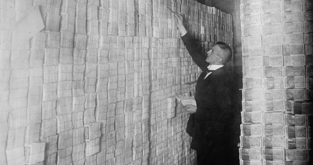 La inflación en la Alemania de Weimar hace que el papel moneda se apile desde el suelo hasta el techo en un banco de Berlín (Alemania). Un banquero lo está contando. Foto: Buyenlarge (Getty Images)